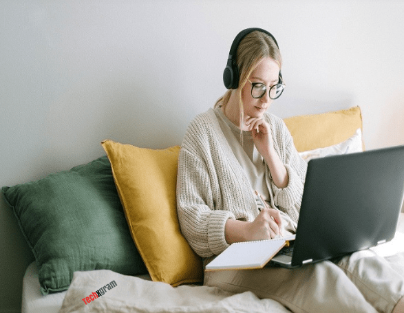 A lady writing a blog at home